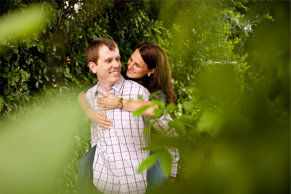 Eleanor Tinsley Park is the best place for engagement pictures in Houston couple embracing through tree