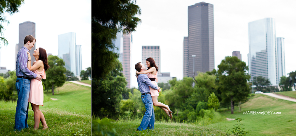 Eleanor Tinsley Park is the best place for engagement pictures in Houston couple embracing in grass with skyline behind